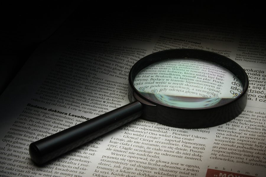 Magnifying glass over printed research